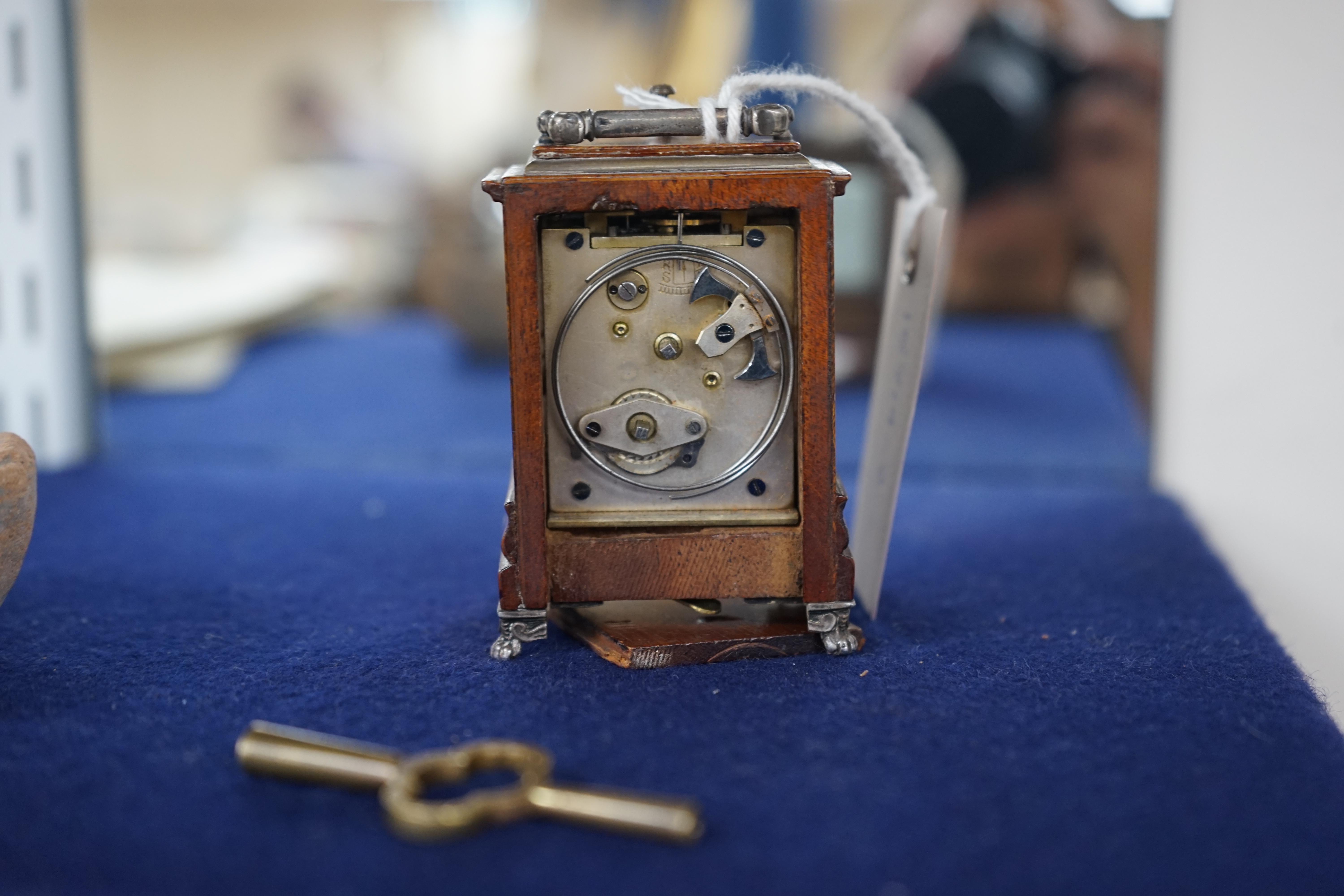 An early 20th century walnut miniature repeating carriage clock, with key, 8.5cm. Condition - fair, currently ticking